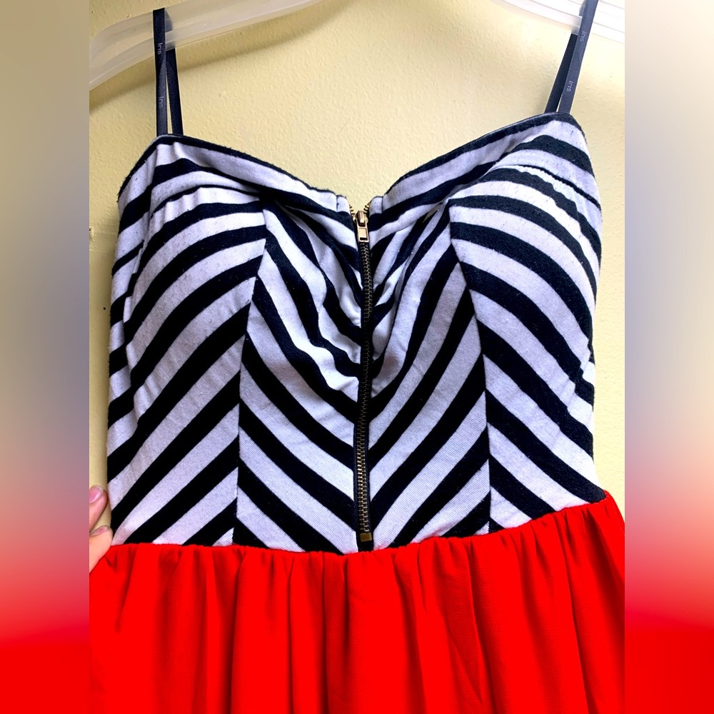 Red bottom with zip-up black and white striped top